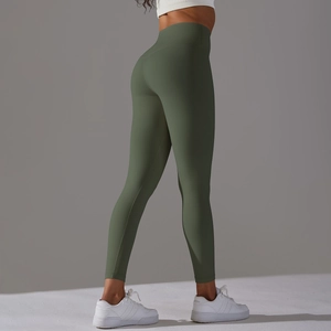 Close-up of olive green high-waisted yoga leggings showing elastic fabric and butt-lift fit