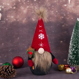 Handmade Christmas gnome with red hat and pine cone details in festive warm setting