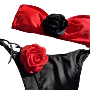 Two-piece contrast bikini with large 3D rose flower accents on red bandeau and black briefs