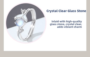 Detail of whale tail ring showing luminous glass stone and zircon setting