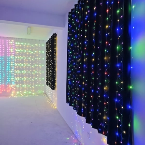 Detail of hanging RGB LED curtain fairy lights with colorful glow on black background