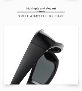 Detail shot of sleek black Y2K punk sunglasses with glossy futuristic large frames