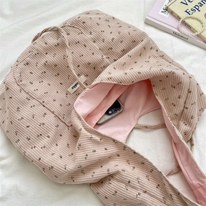 Close-up of pink corduroy floral tote showing internal pocket with smartphone storage
