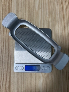 Macro view of a 49g stainless steel wire slicer for butter and cheese on a scale
