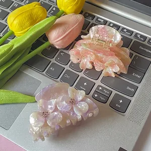 Floral acetate hair claws set in pastel pink and purple with sparkling rhinestones