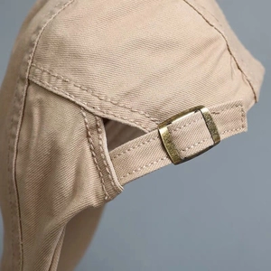 Adjustable buckle detail on khaki canvas beret cap with premium vintage metal fastener