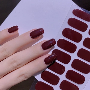 Deep red solid color nail stickers set shown on model hands with professional clean background