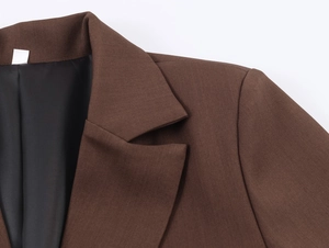 Detailaufnahme des braunen Sakko-Kragens mit feiner Twill-Stoffstruktur an der Schulter