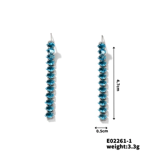 Detail view of long tassel earrings with blue pear-shaped zircon stones and 4.7cm length