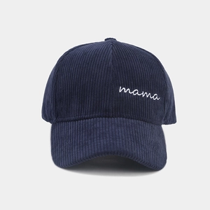 Detailed view of the navy blue corduroy fabric and white mama embroidery on the cap