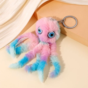 Porte-clés poulpe en peluche dégradé rose et bleu sur fond en soie blanche élégante