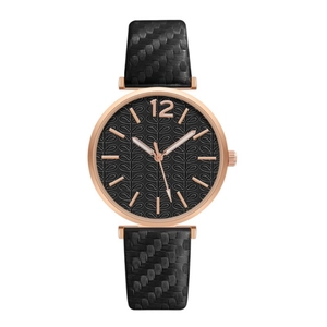 Women's quartz wrist watch with rose gold case and textured black strap in a white background