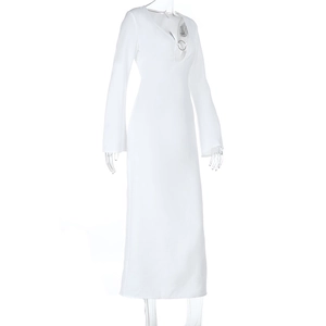 Detail of deep V-neckline with silver metal ring on white long-sleeve knit dress
