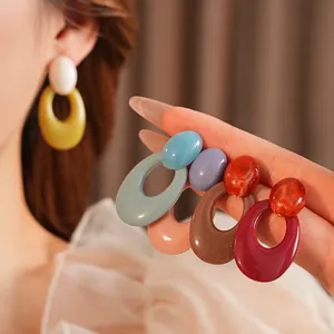 Retro oval hollow resin hoop earrings in assorted vibrant colors with silver needles