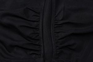 Close-up of black short sleeve top featuring detailed ruched design and woven texture fabric