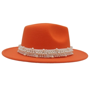 Detail of orange wool felt fedora hat featuring a white faux pearl decorative band