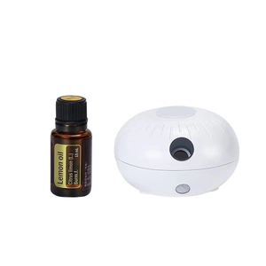 Minimalist white anhydrous aroma diffuser with a 15ml bottle of pure lemon essential oil