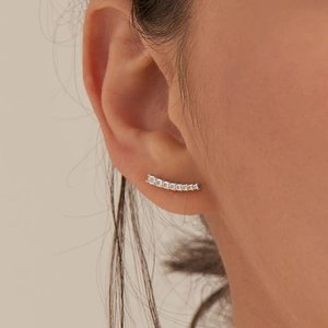 Close-up of minimalist S925 sterling silver curved stud earrings on female ear model