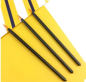 Detailed shot of three slim eyeliners with black handles and fine orange nylon brush tips