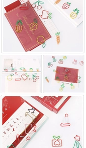 Creative fruit and Christmas shaped paper clips used as decorative bookmarks on cards
