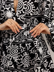 Detail of waist tie-up on black and white mandala print pajama set with long sleeves