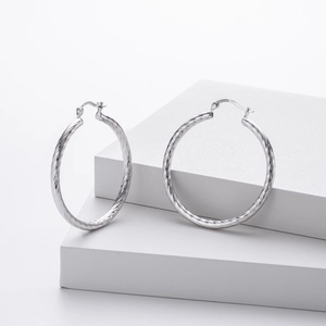 Detailed close-up showing the S925 sterling silver hallmark on twisted hoop earrings