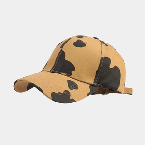 Detailed view of the cow print pattern and stitching on a khaki baseball cap