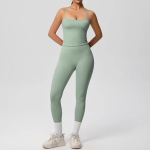 Detail of light green yoga set featuring spaghetti strap sports top and high waist leggings