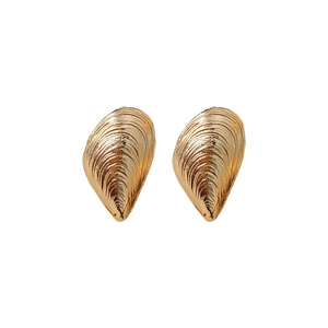 Minimalist gold shell-shaped textured metal hoop earrings with a polished finish