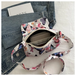 Top view of butterfly print crossbody bag showing interior storage space for makeup