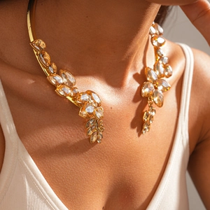 Detail of vintage gold collar necklace with champagne crystals worn by a model
