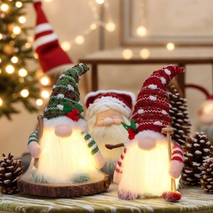 Lighted Christmas gnomes with knitted hats and wooden skis for holiday table decor