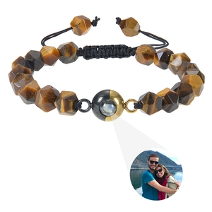 Detailed macro view of faceted tiger eye stone bracelet with custom photo projection bead
