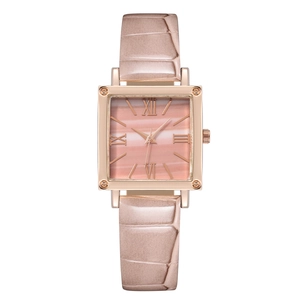 Detail of square pink marble dial with Roman numerals and rose gold case on leather strap