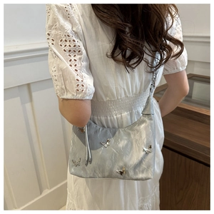 Silver crescent underarm bag with metallic pleats and 3D butterfly details