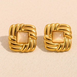 Macro shot of 18K gold plated square cat-eye stud earrings with twisted metal frame