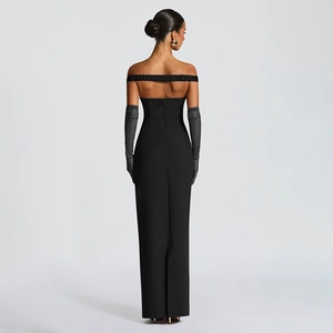 Detail showing the elegant back view of a slim-fit strapless black dress with a center slit