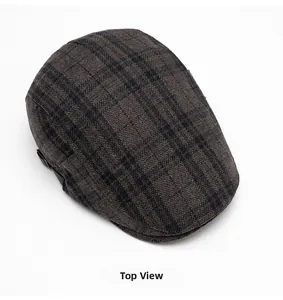 Top view of wool blend ivy cap featuring brown and green plaid pattern with side buckles
