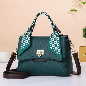 Elegant dark green lychee pattern handbag with a silk scarf and golden hardware