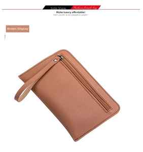Brown leather clutch bag with wrist strap and zipper detail shown from a side view