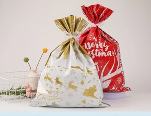 Detailed view of glossy Christmas drawstring gift bags with deer and Merry Christmas print