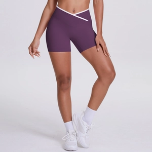 Detail of high waisted yoga shorts featuring a V-cross waist and white piped edges