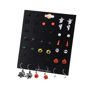 Halloween earring set featuring pumpkin, ghost and spider charms on black card