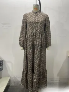 Detail of elegant long-sleeve dress featuring chain print, stand collar and buttons
