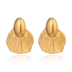 Detailed close-up of golden geometric earrings with radial stripes and drop design