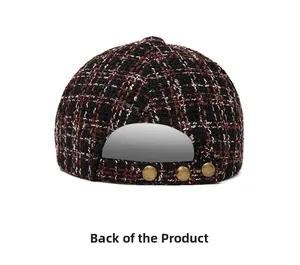 Back view of a tweed newsboy cap in black and red plaid with vintage metal buttons
