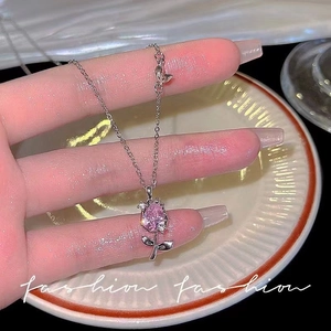 Macro detail of tulip pendant necklace featuring pink zircon stone and silver stem