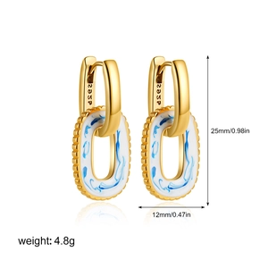 Detail of 18K gold U-shape earrings with S925 silver stamp and blue marble texture