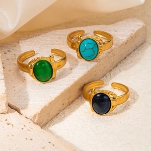 Detailed macro of vintage titanium steel rings with natural stone inlays and gold finish
