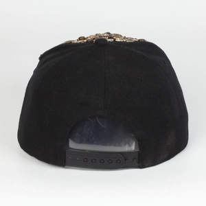 Detailed back view of a black hip-hop cap showing plastic snapback strap and gold studs